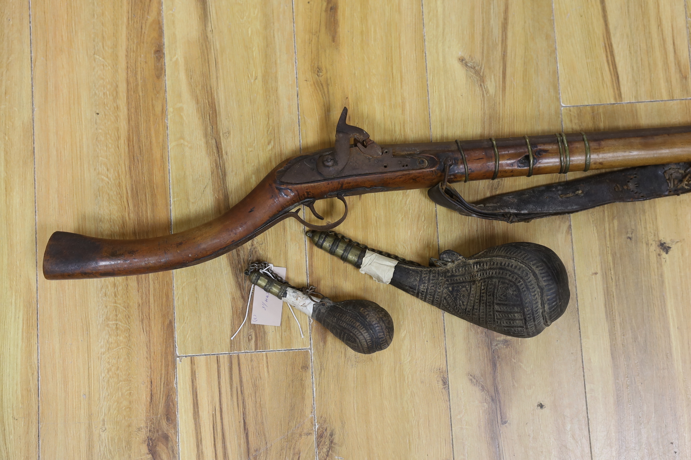 An Afghan percussion rifle and two shot flasks, rifle 143cm